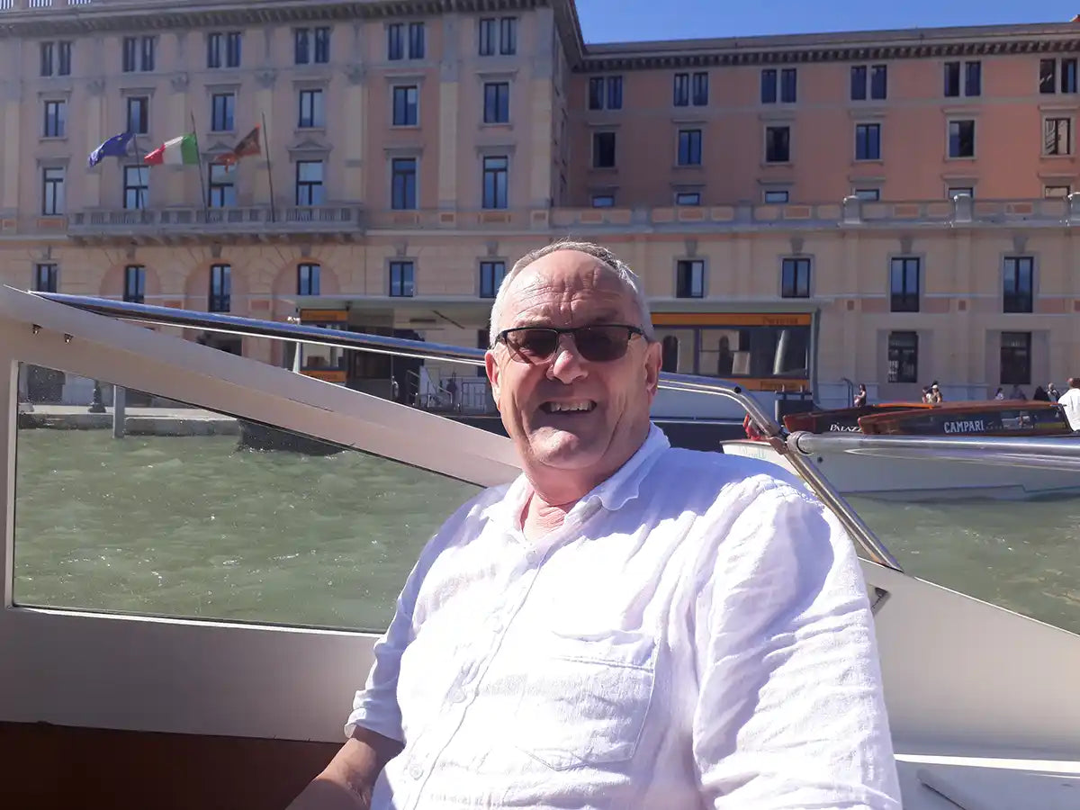 Picture of Colin, Drink Drive Specialist's Lawyer, on a boat in Venice, Italy. Sunny day with another boat in the background.